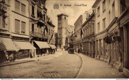 CPA Arlon Aarlen Wallonien Luxemburg, Straße mit Uhrturm, Geschäfte, Autos, Atmosphäre