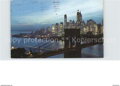 72580746 Manhattan_New_York Nightfall in Lower Manhattan with Brooklyn Bridge