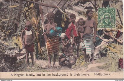 PHILIPPINES - A Negrito family, hut in the background is their home, Postcard