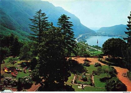 Rovio Lugano TI Park-Hotel Garten Lago-di-Lugano Berge Liegewiese Baeume Terrass